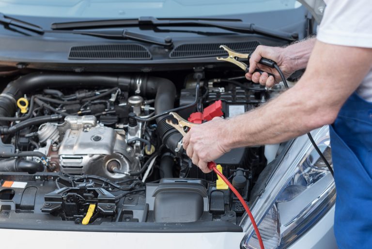 mechanic jump starting car