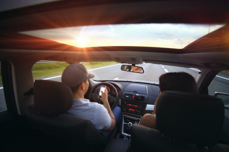 man-using-smartphone-while-driving