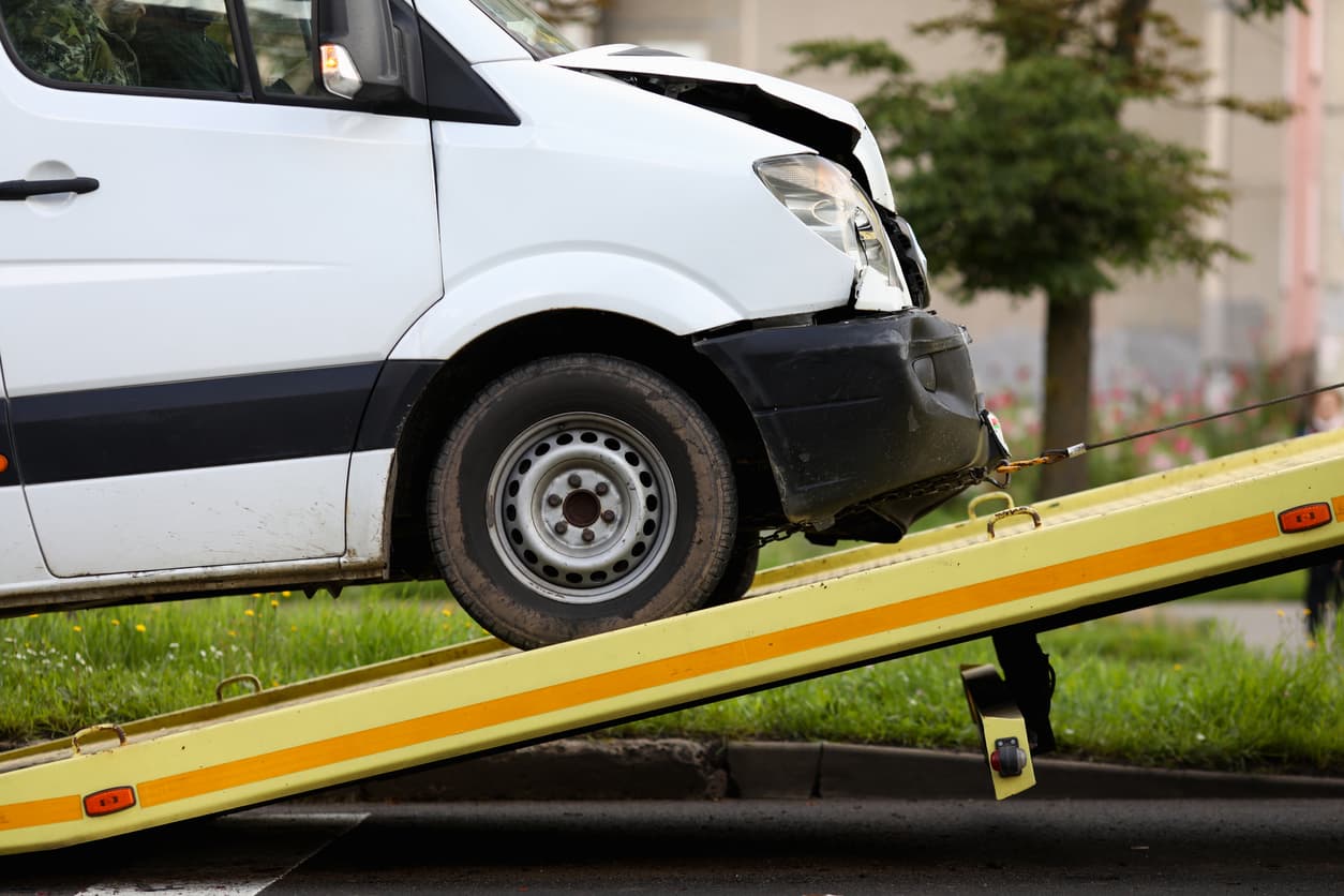 close-up of crashed vehicle being lifted onto a tow truck