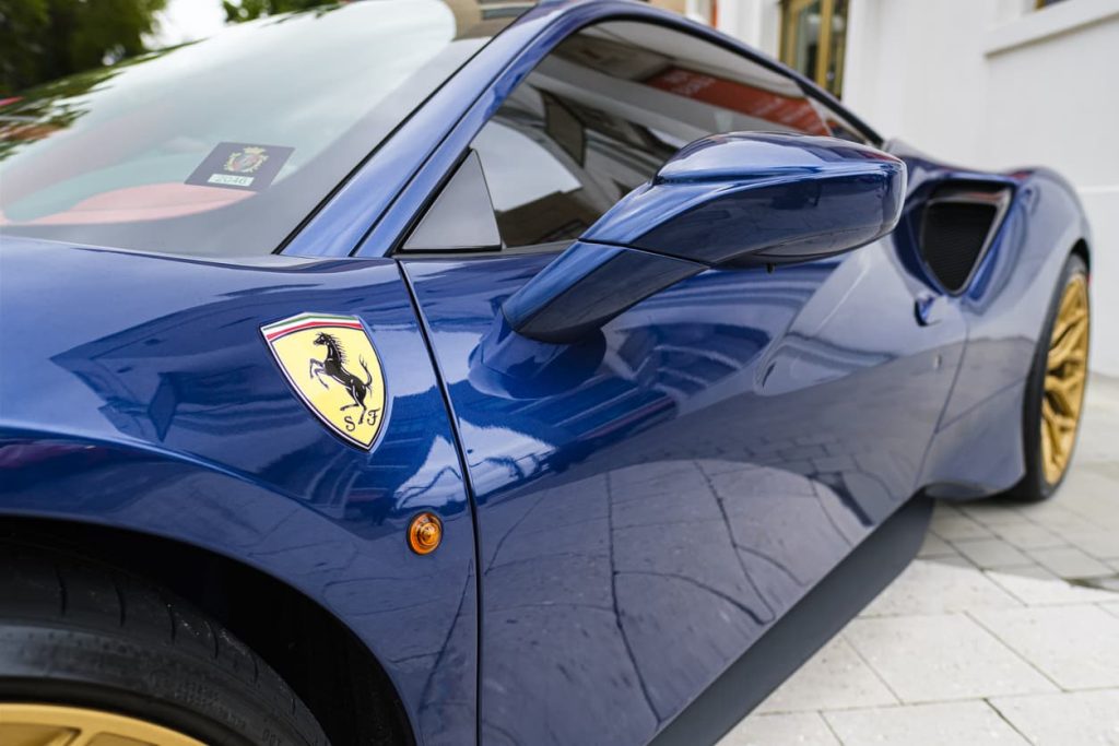 Close up of the side of a blue Ferrari