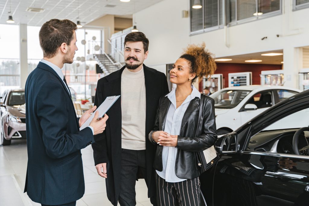 A couple buying a car in a dealership