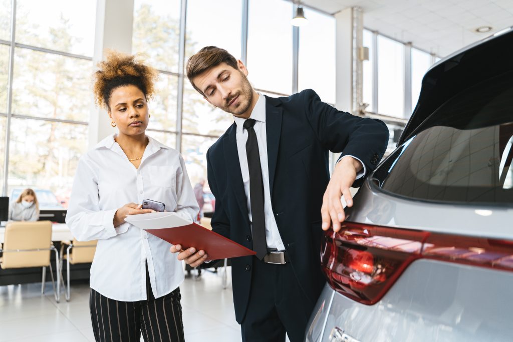 Salesman talking to a potential car buyer