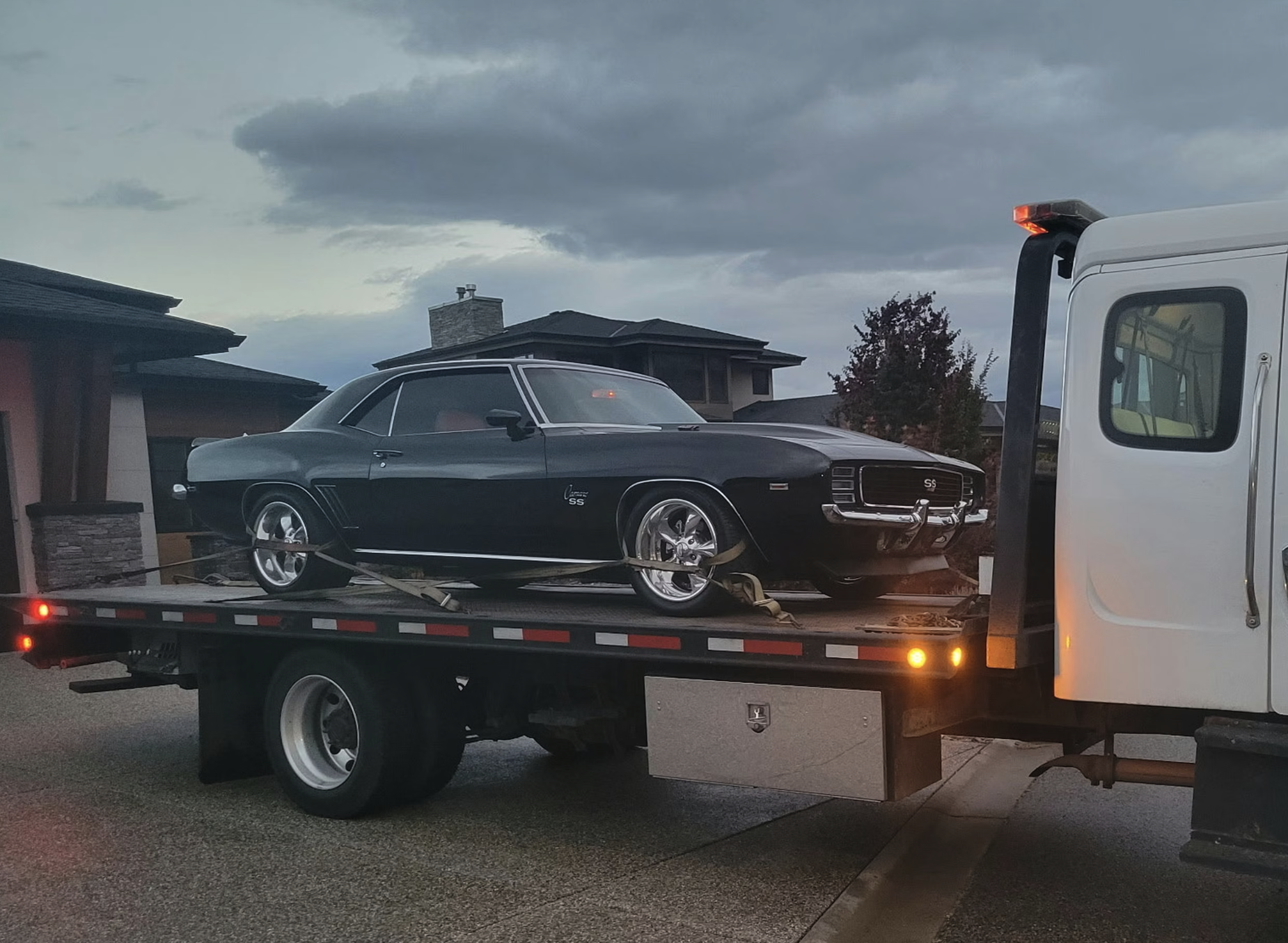 Classic car being transported on flatbed carrier