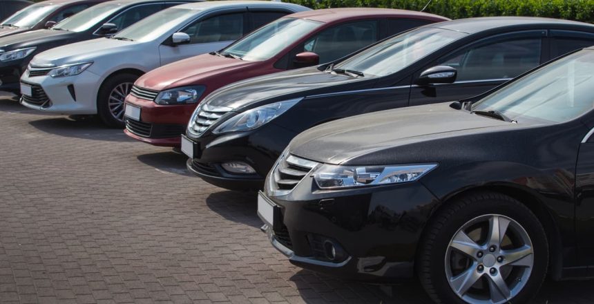 new cars for sale parked at a dealership lot