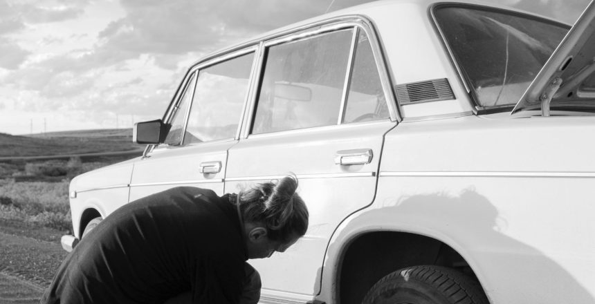 A Man Fixing a Flat Tire