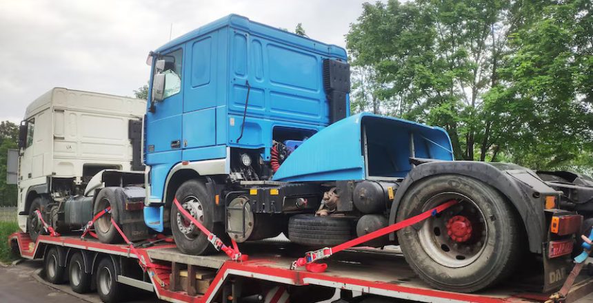 Flatbed trailer carrying heavy construction equipment for transport