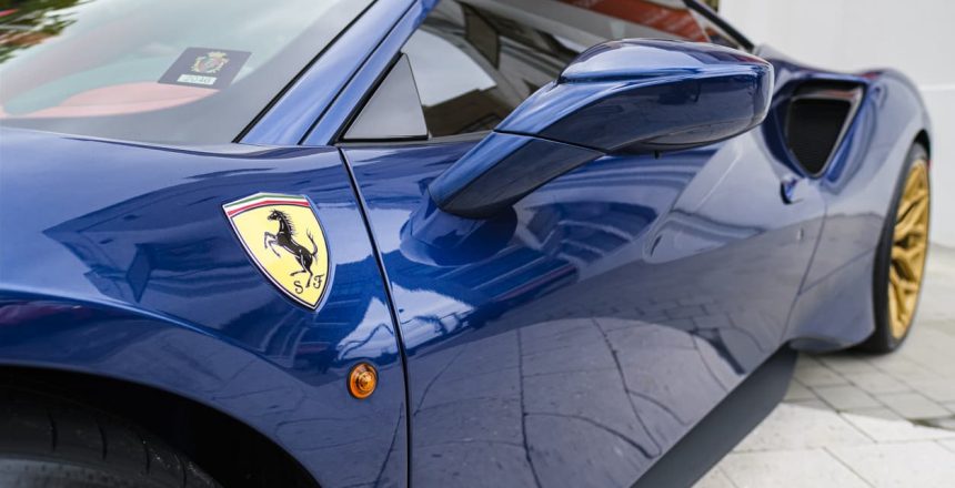 Close up of the side of a blue Ferrari