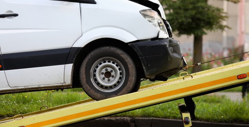 close-up of crashed vehicle being lifted onto a tow truck