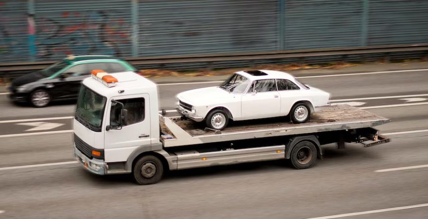 singlelift-tow-truck-with-disabled-vintage-retro-sedan-flatbed_909686-1617