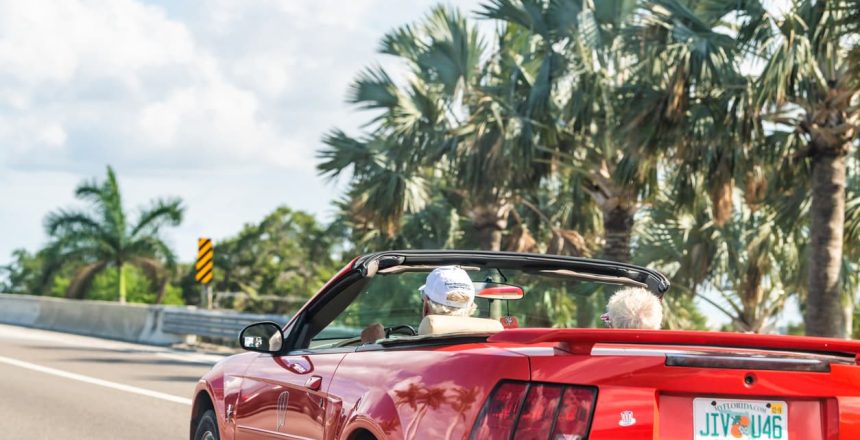 An older couple in Florida driving to use a snowbird car shipping service.