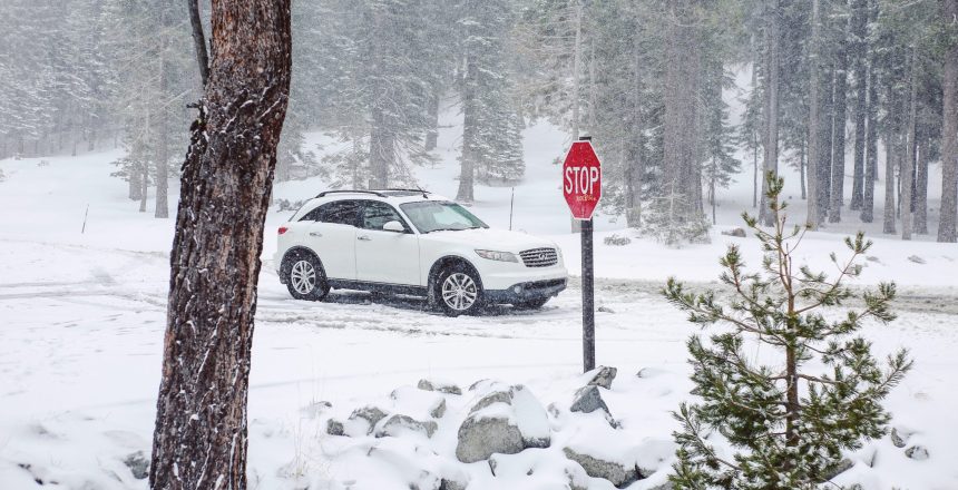 white sedan on snow covered road during daytime